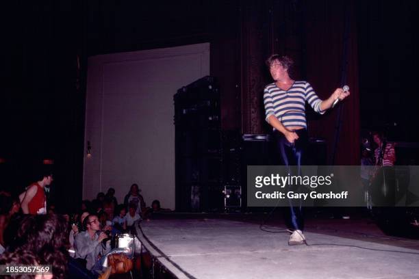 English Rock singer Joe Elliott, of the group Def Leppard, performs onstage at the Palladium, New York, New York, August 1, 1980. Visible in the...