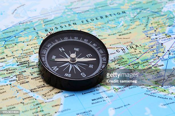 compass and map - china east asia stock pictures, royalty-free photos & images
