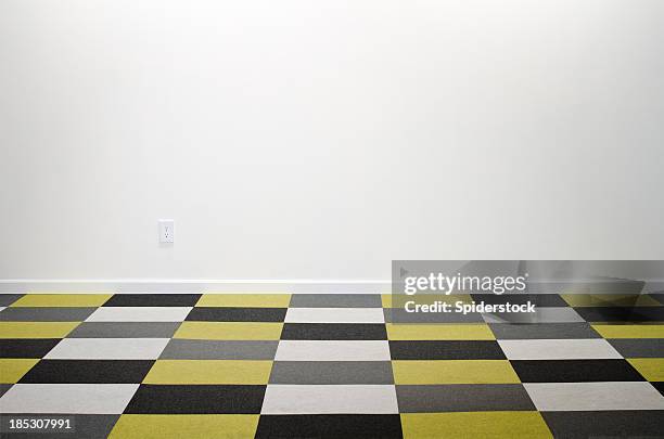empty room with checkered carpeting - skirting board stock pictures, royalty-free photos & images