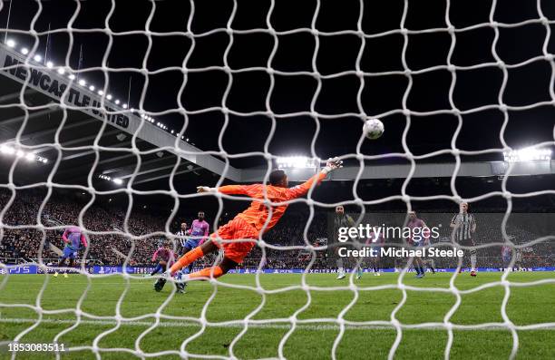 Mike Maignan of AC Milan fails to save a shot from Joelinton of Newcastle United, a shot which results in Newcastle United's first goal during the...