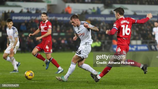 Josh Tymon of Swansea City crosses tha ball forward while being followed by Jonny Howson of Middlesbrough during the Sky Bet Championship match...