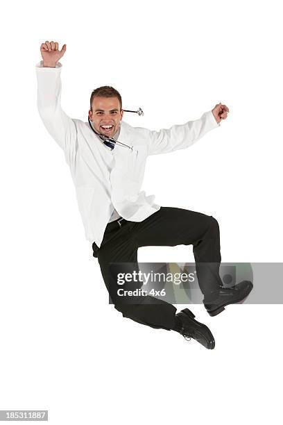 male doctor jumping in excitement - doctor leaping stock pictures, royalty-free photos & images