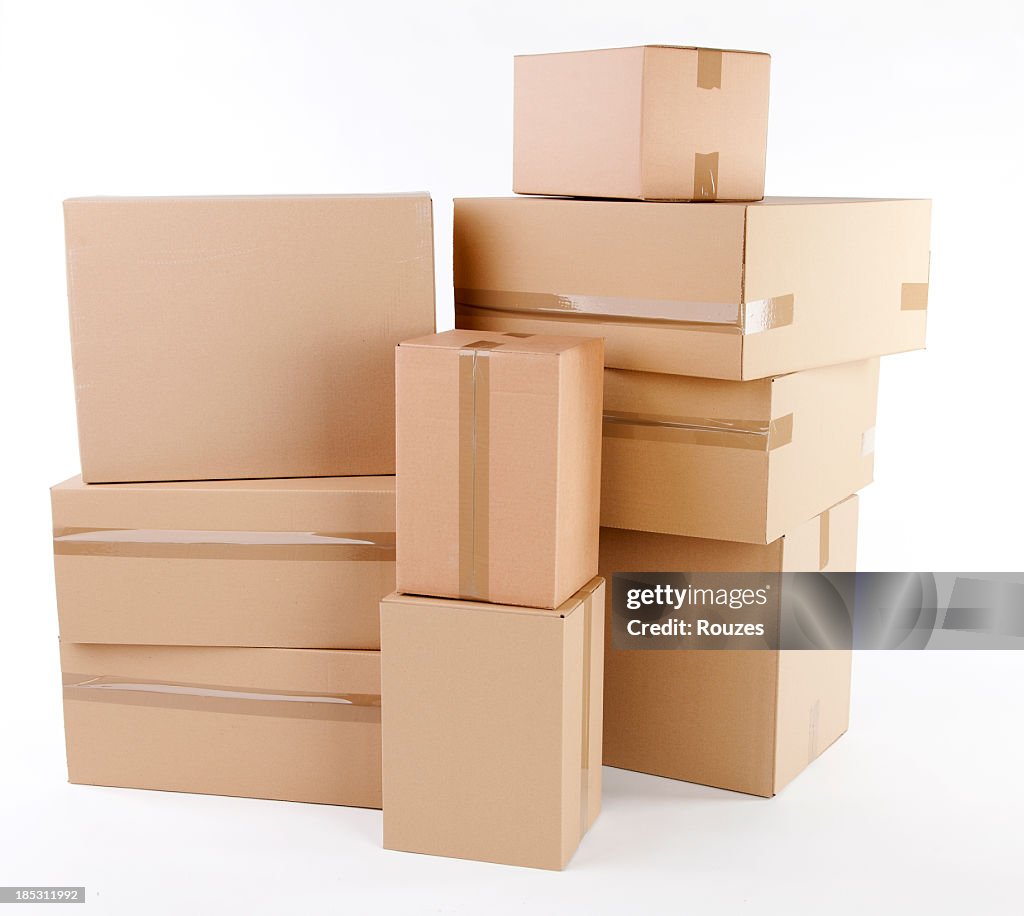 Stack of closed cardboard boxes on white background