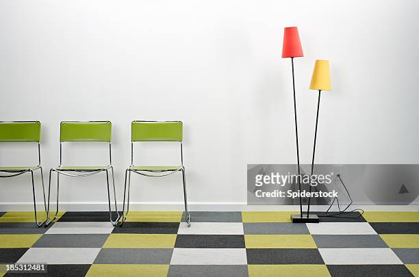empty room with checkered carpeting - standing lamp stock pictures, royalty-free photos & images