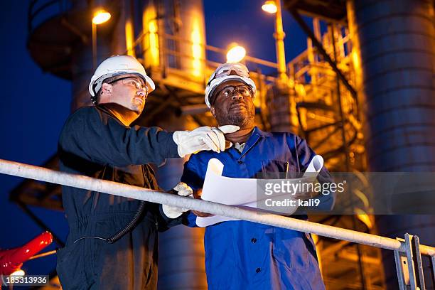 chemical plant workers at night - oil refinery stock pictures, royalty-free photos & images