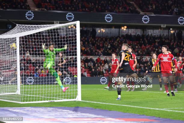 Liam Delap of Hull City scores their team's first goal past Seny Dieng of Middlesbrough during the Sky Bet Championship match between Middlesbrough...