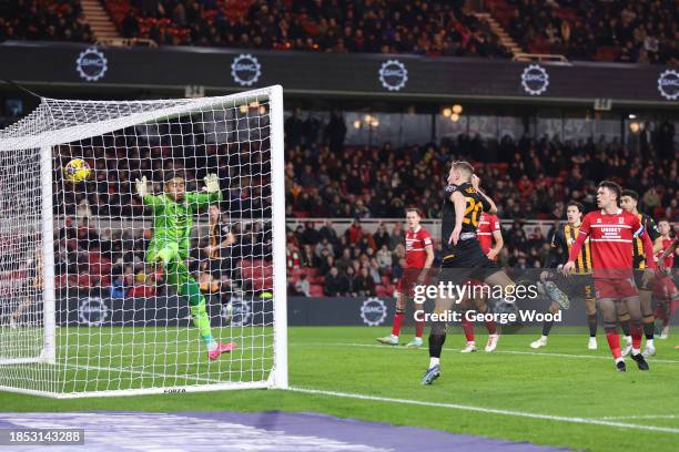 Liam Delap of Hull City scores their team's first goal past Seny Dieng of Middlesbrough during the Sky Bet Championship match between Middlesbrough...