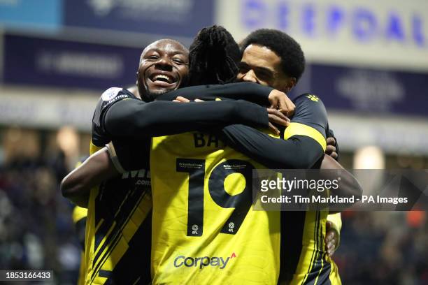 Watford's Vakoun Issouf Bayo celebrates scoring their side's fourth goal of the game with Edo Kayembe and Jamal Lewis during the Sky Bet Championship...