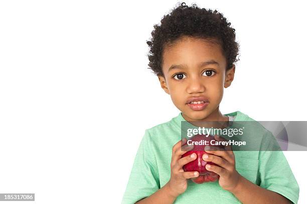 süße kleine junge mit apfel - child holding apples stock-fotos und bilder