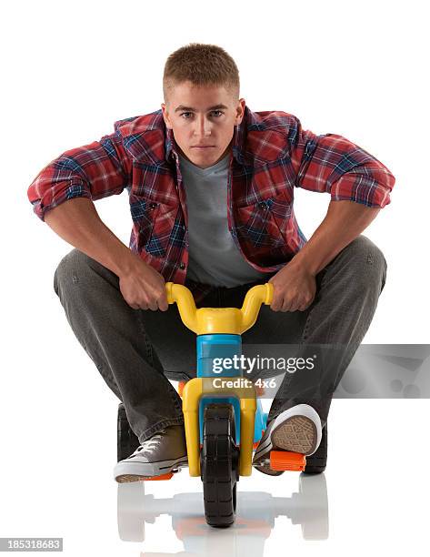man riding a tricycle - tricycle stock pictures, royalty-free photos & images