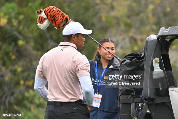 Tiger Woods and his daughter and caddie, Sam Woods, are seen near the cart on the ninth fairway during the first round of the PNC Championship at...