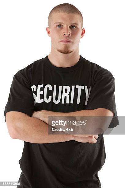 security guard standing with his arms crossed - uitsmijter stockfoto's en -beelden