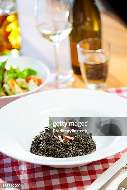 octopus with black rice - arroz negro - arroz negro stock pictures, royalty-free photos & images