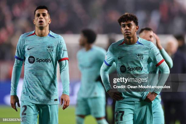 Joao Cancelo and Lamine Yamal of FC Barcelona look dejected following the team's defeat during the UEFA Champions League match between Royal Antwerp...