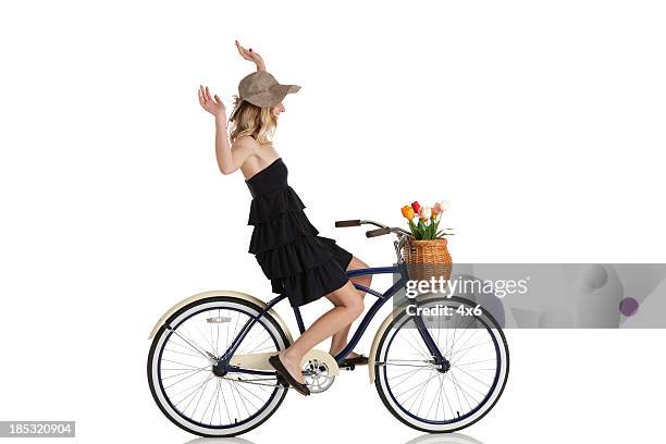 woman cycling without holding handlebars - hands free cycling stock pictures, royalty-free photos & images