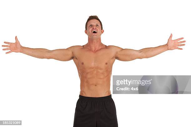 bare chested man standing with arms extended - arms outstretched isolated stock pictures, royalty-free photos & images