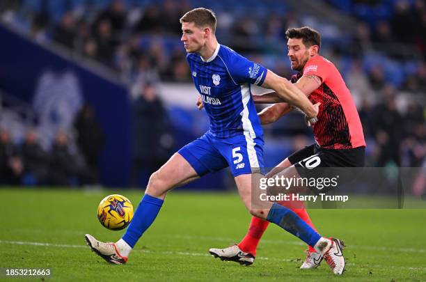 Mark McGuinness of Cardiff City battles for possession with Lukas Jutkiewicz of Birmingham City during the Sky Bet Championship match between Cardiff...