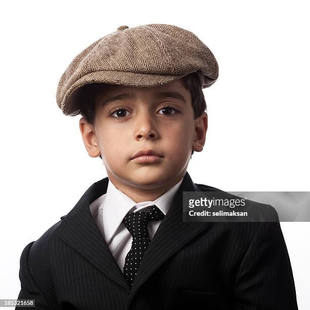 portrait of little boy wearing striped suit and flat cap - golf driver stock pictures, royalty-free photos & images