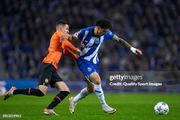 Dmytro Kryskiv of Shakhtar Donetsk competes for the ball with Jorge Sanchez of FC Porto during the UEFA Champions League match between FC Porto and...