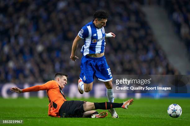 Dmytro Kryskiv of Shakhtar Donetsk competes for the ball with Jorge Sanchez of FC Porto during the UEFA Champions League match between FC Porto and...