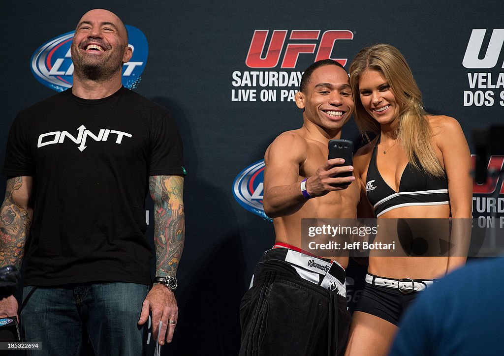 joe-rogan-laughs-as-john-dodson-takes-a-picture-with-ufc-octagon-girl-chrissy-blair-on-stage.jpg