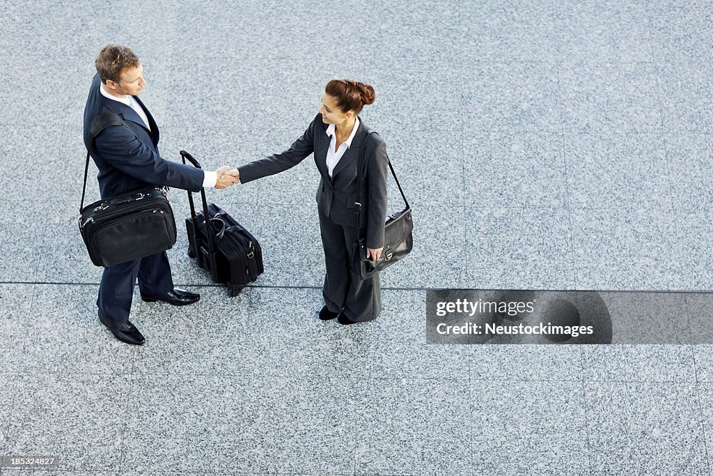 Business Partners Shaking Hands At Airport