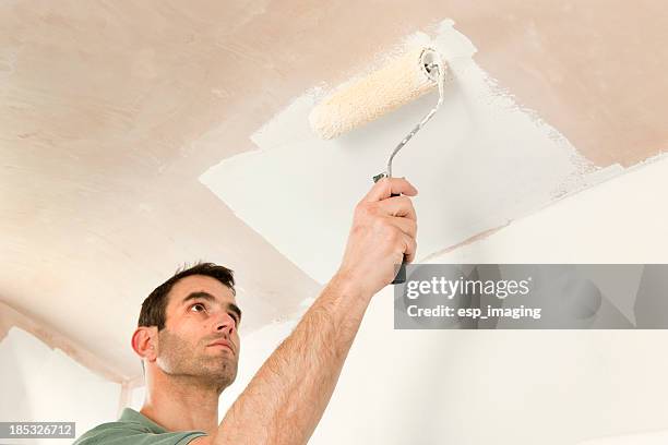 painting a ceiling by roller - ceiling stock pictures, royalty-free photos & images