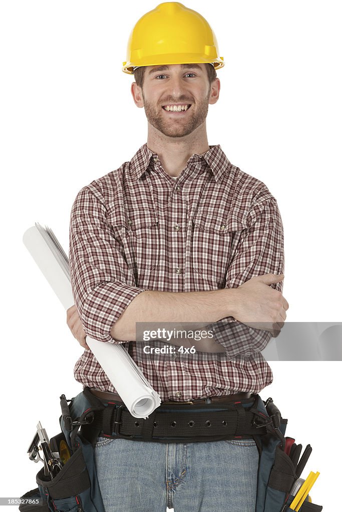 Happy construction worker holding a blueprint