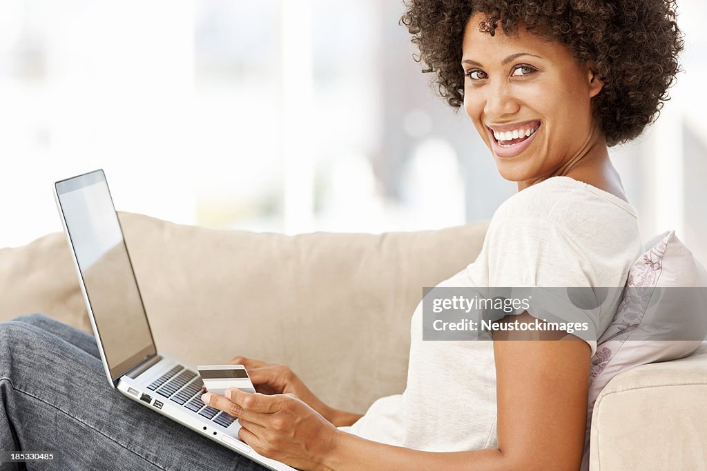 Woman Using a Laptop on the Couch