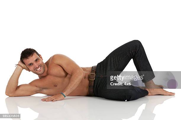 bare chested man reclining - lying on side stockfoto's en -beelden