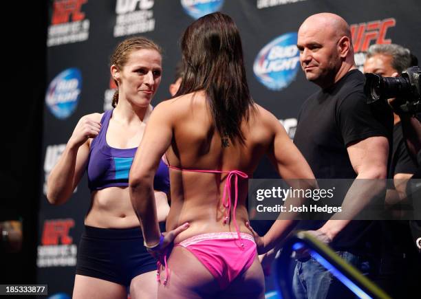 Sarah Kaufman faces off with opponent Jessica Eye during the UFC 166 weigh-in event at the Toyota Center on October 18, 2013 in Houston, Texas.