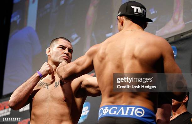 Cain Velasquez faces off with opponent Junior Dos Santos during the UFC 166 weigh-in event at the Toyota Center on October 18, 2013 in Houston, Texas.