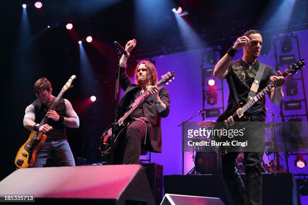 Brian Marshall, Myles Kennedy and Mark Tremonti of Alter Bridge perform on stage at Wembley Arena on October 18, 2013 in London, England.