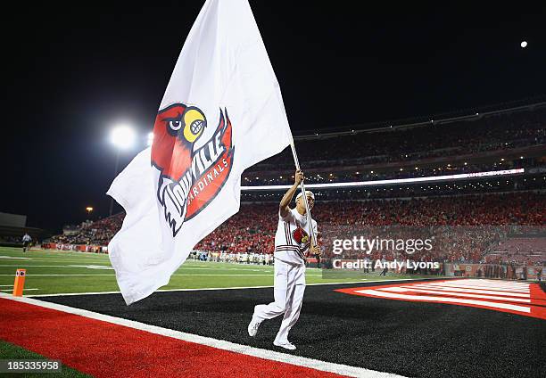 Louisville Cardinals cheerleader waves a flag during the game against the Central Florida Knights at Papa John's Cardinal Stadium on October 18, 2013...