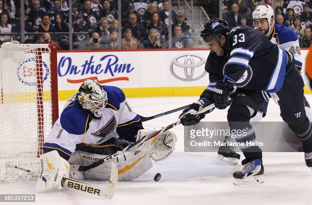 Brian Elliott of the St. Louis Blues blocks a shot on goal by Dustin Byfuglien of the Winnipeg Jets in second-period action of an NHL game at the MTS...