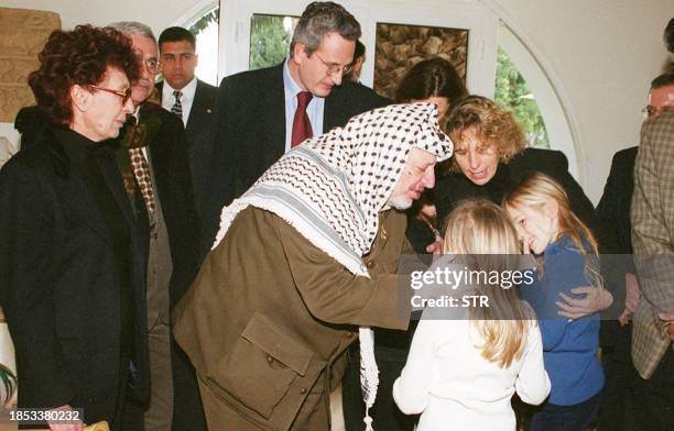 Palestinian leader Yasser Arafat offers his condolences to the grand daughters of late Italian prime minister Bettino Craxi, as Craxi's wife Anna ,...