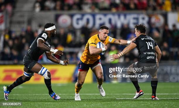 Belfast , United Kingdom - 16 December 2023; James Hume of Ulster is tackled by Siya Kolisi, left, and Henry Arundell of Racing 92 during the...