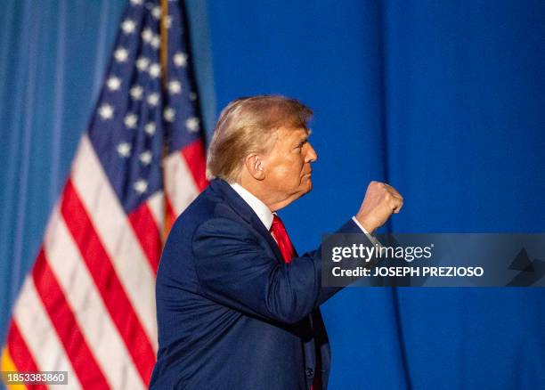 Former US President and 2024 Republican presidential hopeful Donald Trump leaves after speaking during a campaign rally at the University of New...