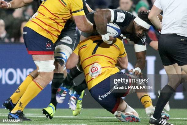 Racing92's South African flanker Siya Kolisi is taclked by Ulster's Irish flanker Nick Timoney during the European Rugby Champions Cup pool 2 rugby...