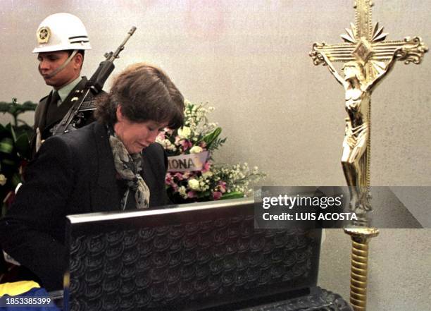 Relative of slain police officer Ramiro Andres Soto cries over the coffin in Bogota, Colombia 31 August 2000. Soto was killed 30 August 2000 during a...