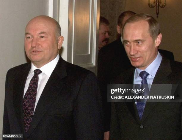 Russian Acting President Vladimir Putin and Moscow Mayor Yuri Luzhkov arrive prior their meeting in Moscow, 23 March 2000. Putin remains firm...