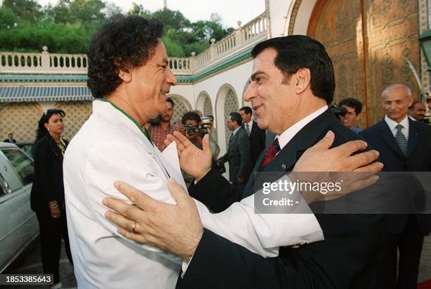 Libyan leader Moamer Kadhafi is welcomed by Tunisian President Zine El Abidine Ben Ali 02 August 2000, at Carthage presidency palace in Tunis....