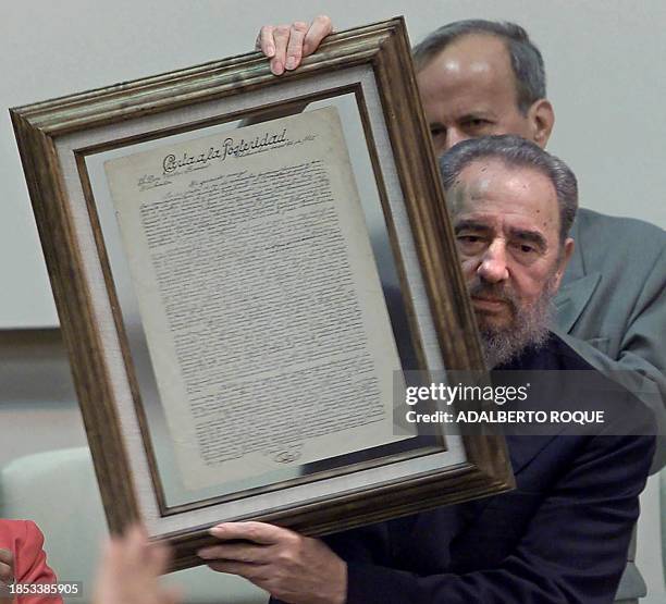 Cuban President Fidel Castro shows a replica of a Benito Juarez's Letter for Posterity, 26 July 2000, in Havana, Cuba. Castro was honores with the...
