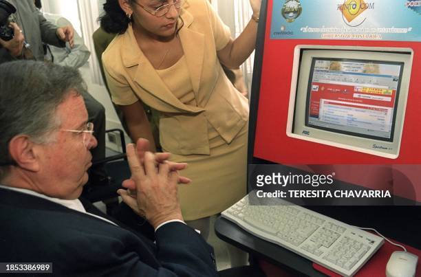 President of Costa Rica Miguel Angel Rodriguez opens his email account 31 May, 2000 in the main building of the Post Office in San Jose, Costa Rica....