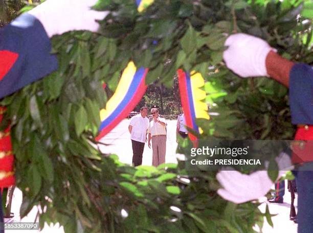The presidents of Columbia and Venezuela, Andres Pastrana and Hugo Chavez , observe a floral offering before the monument to Simon Bolivar, in the...