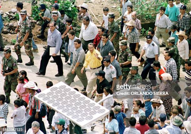 The president of Honduras, Carlos Flores walks, 05 May 2000, on the principle avenue of San Francisco, Lempira, a community that has converted to the...