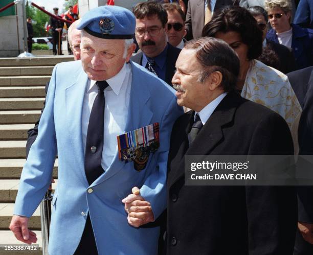 Retired Colonel John Gardam escorts Algerian President Abdelaziz Bouteflika 15 May 2000 during a visit to the Peacekeeping Monument in Ottawa,...