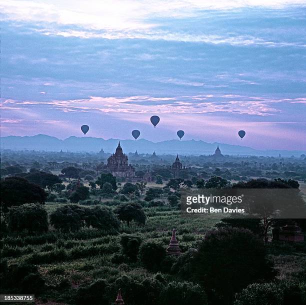 At sunrise five hot air balloons fly over the great ancient temples of Bagan as viewed from the Shwesandaw Temple. In all, there are more than 2,000...