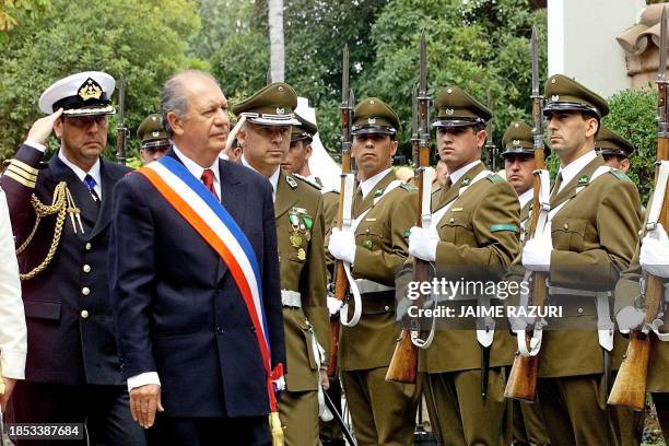 Ricardo Lagos, salutes the president of Chile, as he walks into the residence of the presidential palace in Valparaiso, Chile, 11 March, 2000....