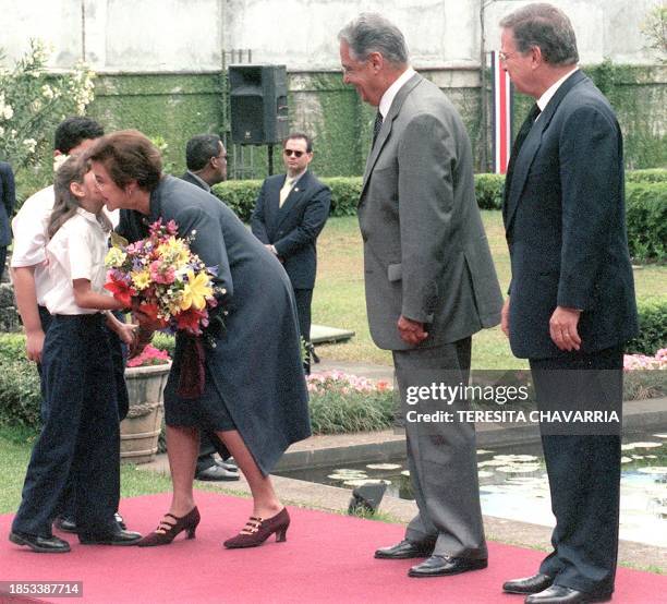 Children bring flowers to Ruth de Cardoso , the first lady of Brazil, 04 April 2000, accompanied by her husband, the president of Brazil, and...